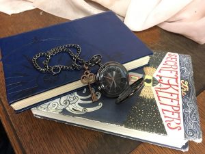 Reuben’s pocket watch and key with the journal he finds at the lighthouse.