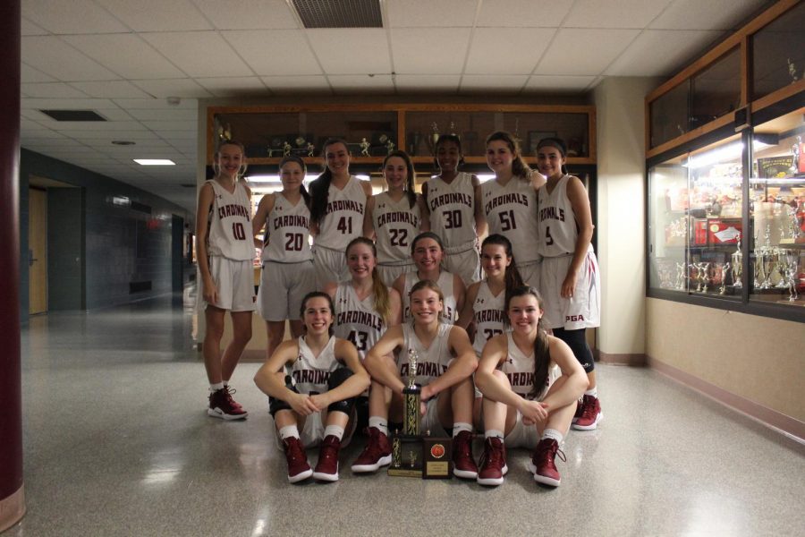 Girls Basketball holds the third place trophy after winning against Blue Mountain Lady Eagles.