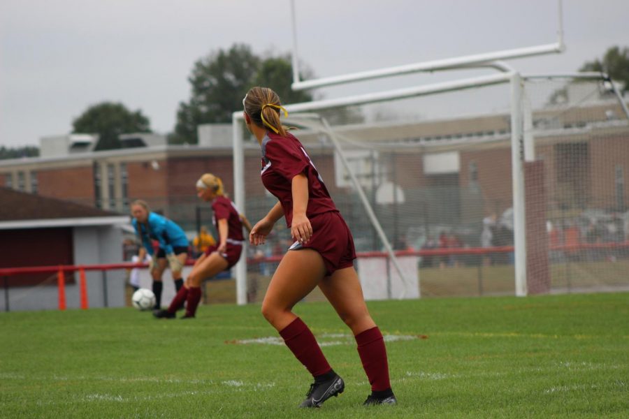 McKenna Lengle watches and waits for Gabi Miller to boot the ball.