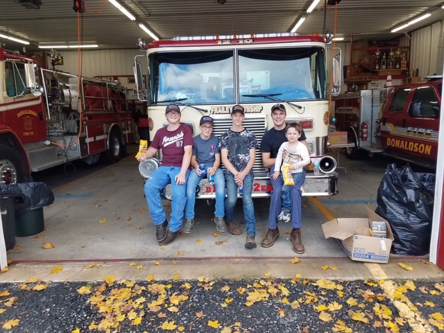 All four Junior Firemen sitting on a firetruck at Donaldson Fire Company.