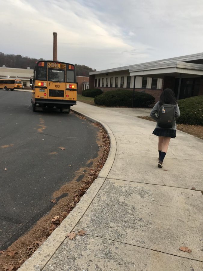 Tran Hoang Thuy Vy walking to get on her bus to take her to Nativity High School.