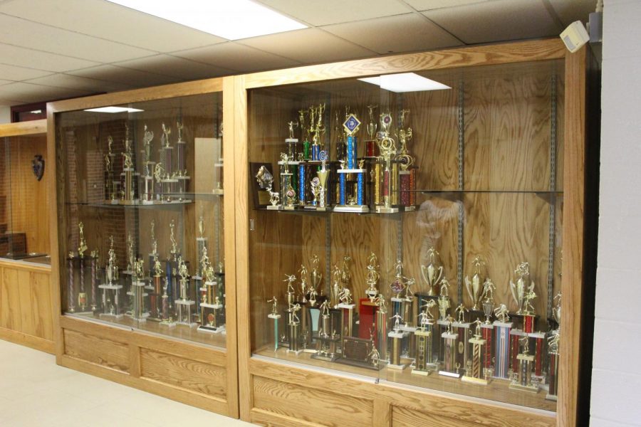 Nate Minnichs two display cases filled with trophies.