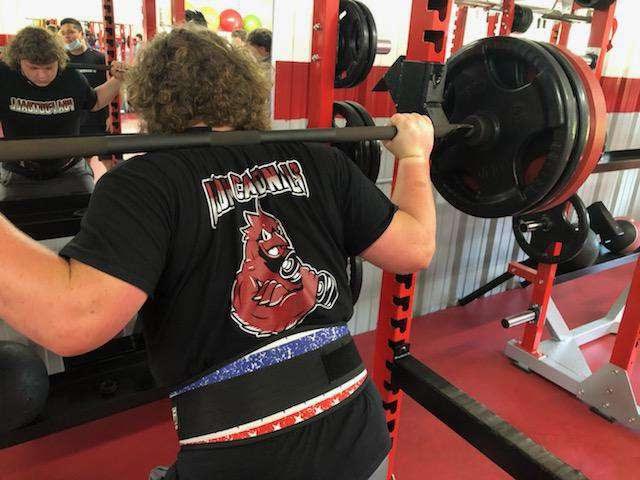 Sophomore, Carter Raudabaugh, squatting weights preparing for the first ever Cardinal Lift-A-Thon.