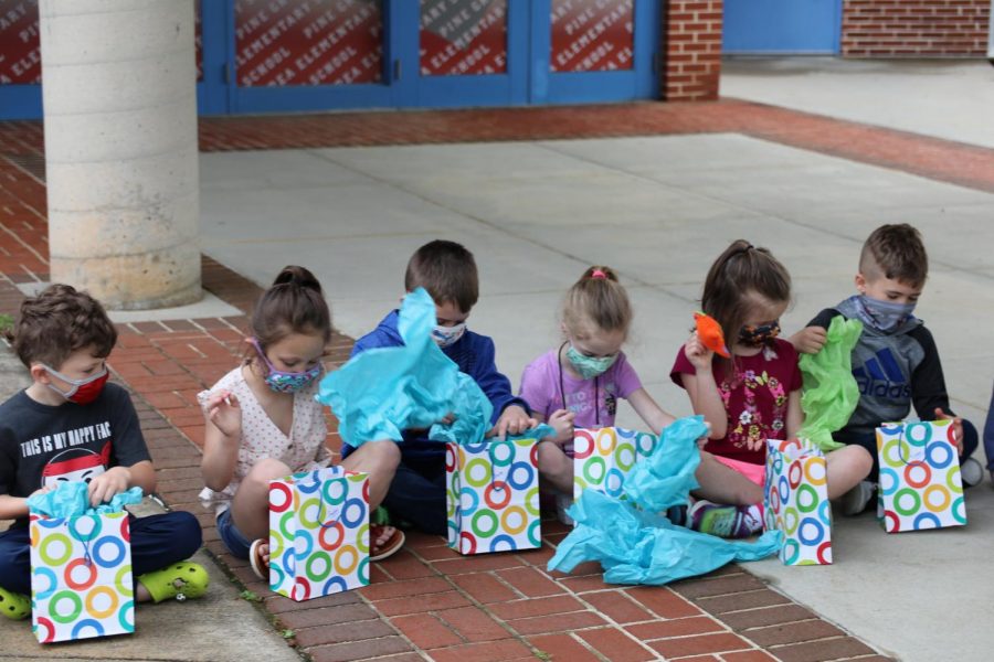 Mrs.Allars kindergarten class opening up their presents with the monsters that the textile design class made for them.