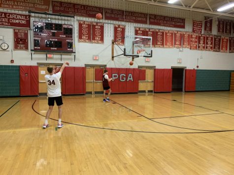Chase Sarge, freshman, and Brandon Unger, junior, practicing their shots at practice.