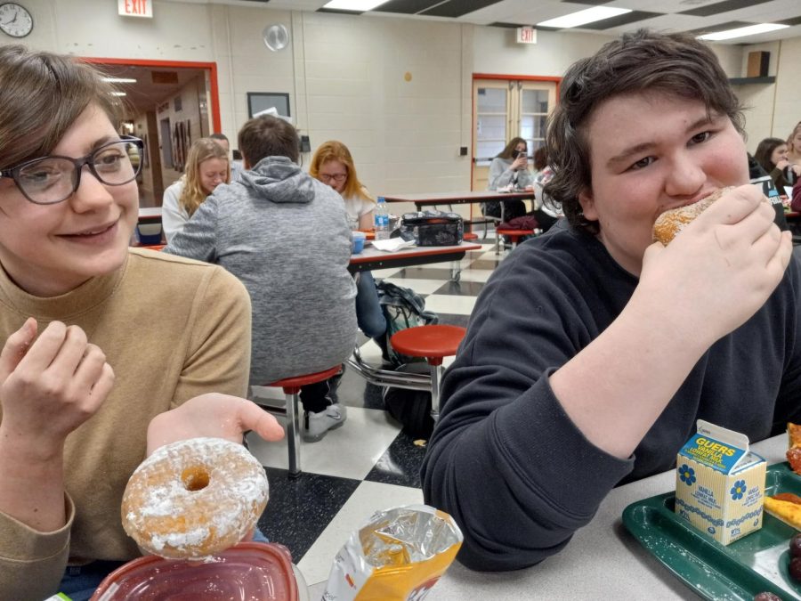 Beth Wagner, sophomore, and Hunter Moyer, sophomore, enjoying their doughnuts on Fastnact Day.