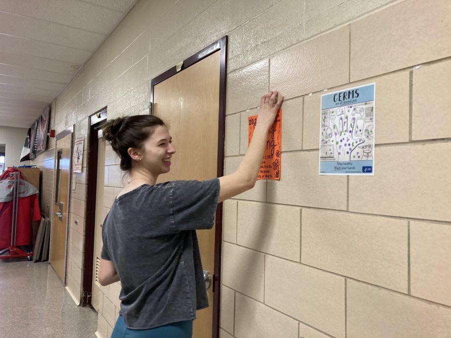 As+Student+Council+prepares+for+the+Spring+Fling%2C+Lexi+Butler%2C+freshman%2C+hangs+the+poster+on+the+wall.+Im+excited+for+the+dance%2C+Butler+said.+As+preparations+are+underway%2C+the+dance+is+met+with+enthusiasm+from+many+students.