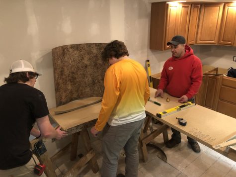Allen Wolff, ’93 alumnus, teaches his students at STC North how to wrap a counter top.