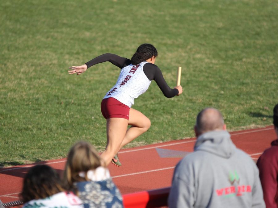 Mikaili Donmoyer, senior, exploding from her blocks at the beginning of the 4x100 relay race.