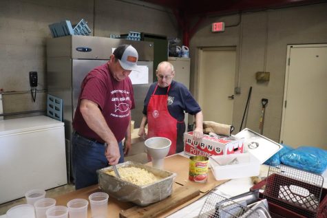 David Harring, left, and Thomas Schwarz, right, prepare quarts of the world famous mac and cheese, to be sold along with meals.