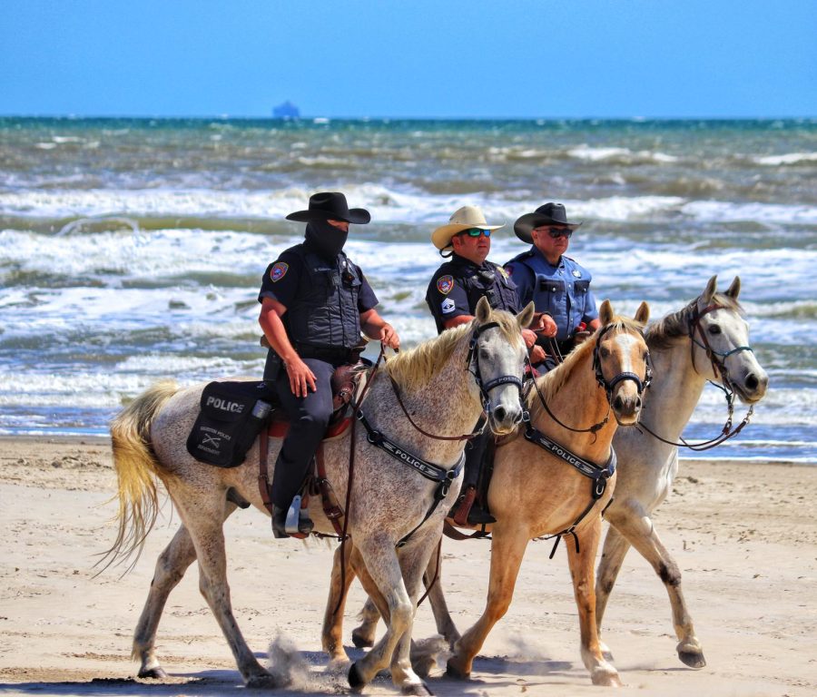 The Galveston Police patrol the beach in the morning.