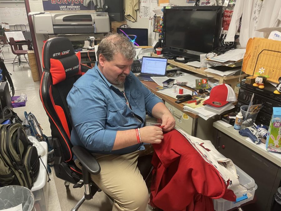Ken Gibson, PGAHS Band Director, mending band uniforms to prepare for the 2022 Band Disney Trip.
