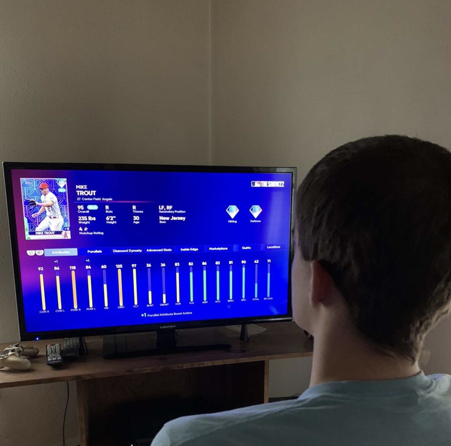 Dalton Geesey, senior, looks at Mike Trouts stats while playing the new MLB the Show 22.
