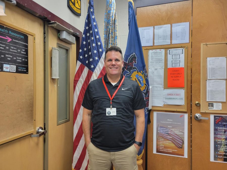 Lieutenant Colonel Farson, the new JROTC instructor, stands by the flags in the JROTC classroom during his third week of teaching. After thirty three years in the military, LTC Farson is up for the challenge that teaching brings. Teaching is something new and a challenge, said LTC Farson.