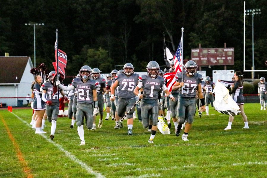 The Pine Grove Cardinals varsity football team runs through the banner prior to the Homecoming game against the Jim Thorpe Olympians.