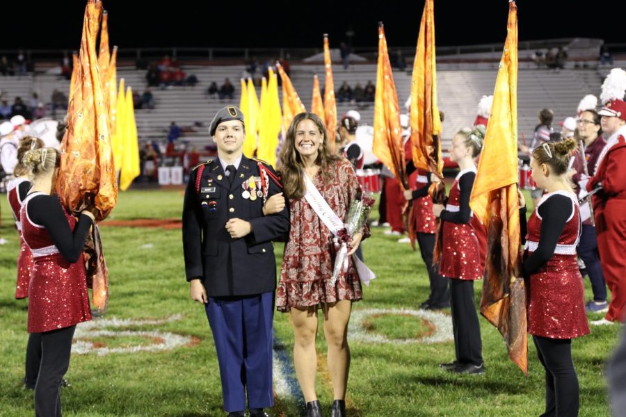 Mia Jefferson, senior, escorted by Konnor Barry, senior, during the halftime Homecoming ceremony.