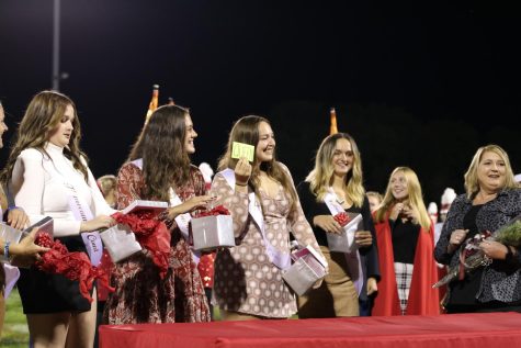 Katie Herring, senior, pulls the queen card out of a box, making her become the next Homecoming Queen.