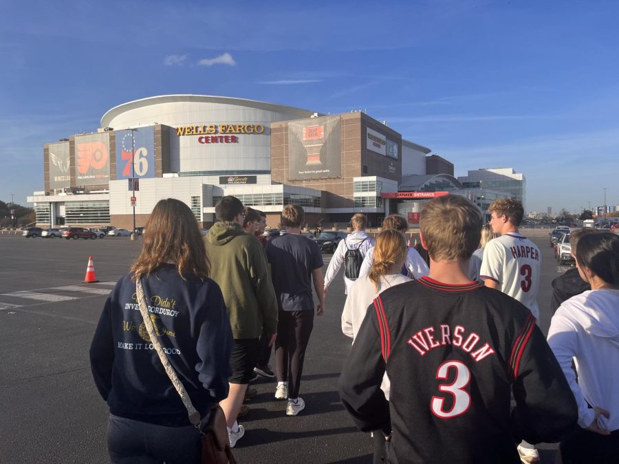 Travel Club Members walk towards Wells Fargo Center for their tour and to watch the 76ers shoot around before their game against the New York Knicks.