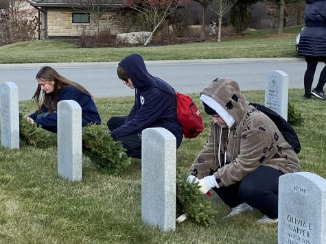 Autumn Gantz, senior; Coen Zerbe, junior; and Fiona Zerbe, freshman, place wreaths on graves at Fort Indiantown Gap National Cemetery.