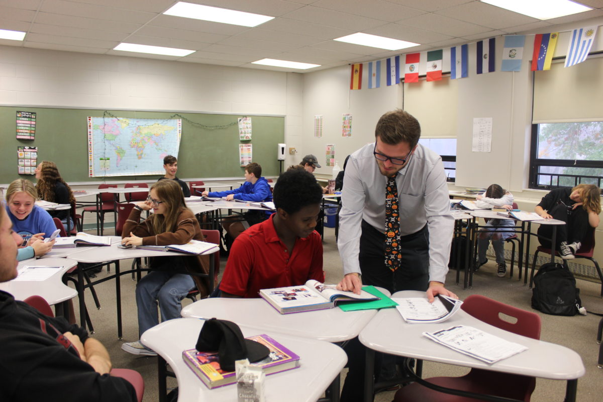 Mr. LeVan helps a student review for his Spanish test.