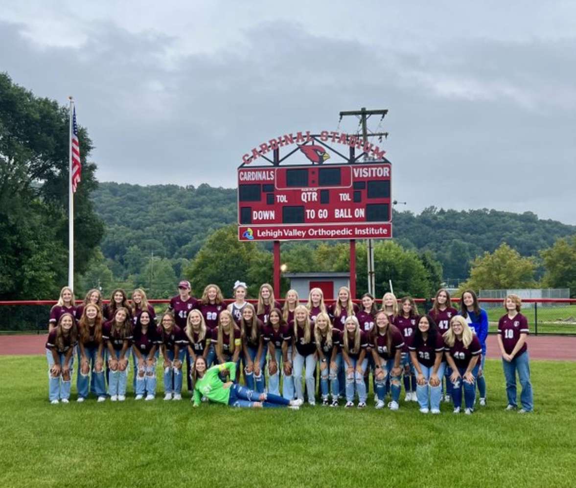 The Pine Grove Area Girl Soccer Team stands and poses for a photo after Meet the Cardinals Night. The girls were individually announced on the track before the picture.