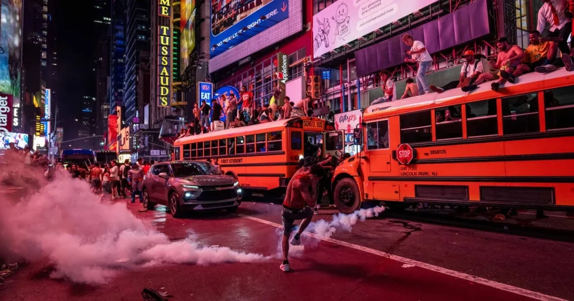 NYPD officers near crowds and damaged vehicles outside Madison Square Garden after a Knicks game