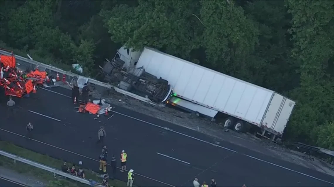 A white semi-truck off Route 30 in a wooded area after a multi-vehicle crash