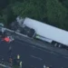 A white semi-truck off Route 30 in a wooded area after a multi-vehicle crash